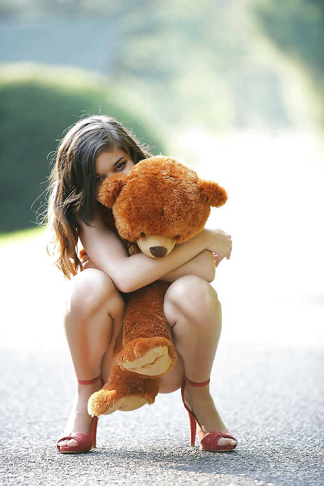 Girl Nika  playing with her teddy bear #27469947