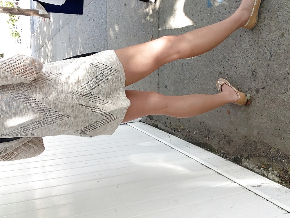White girl's legs at bus stop