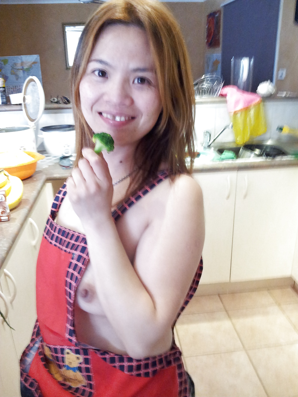 Chinese wife posing in kitchen