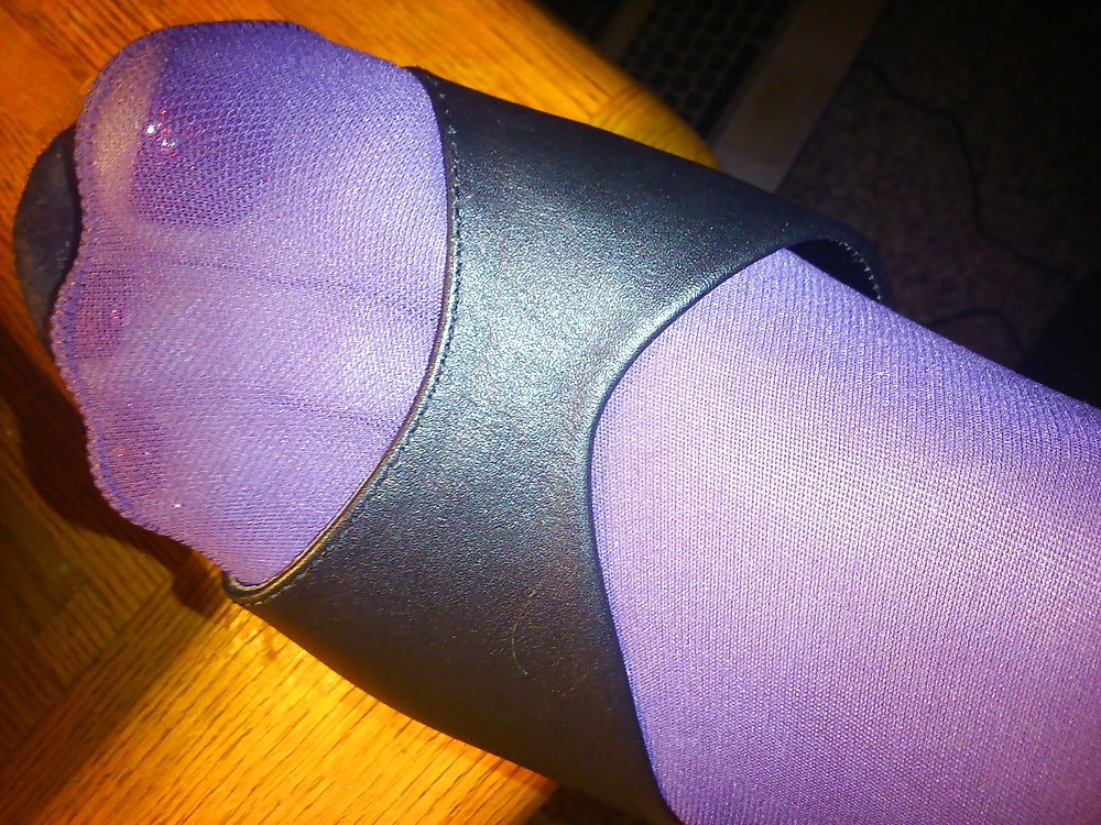 Feet And Legs In Purple Stockings, Leather Dress And Heels #33525462