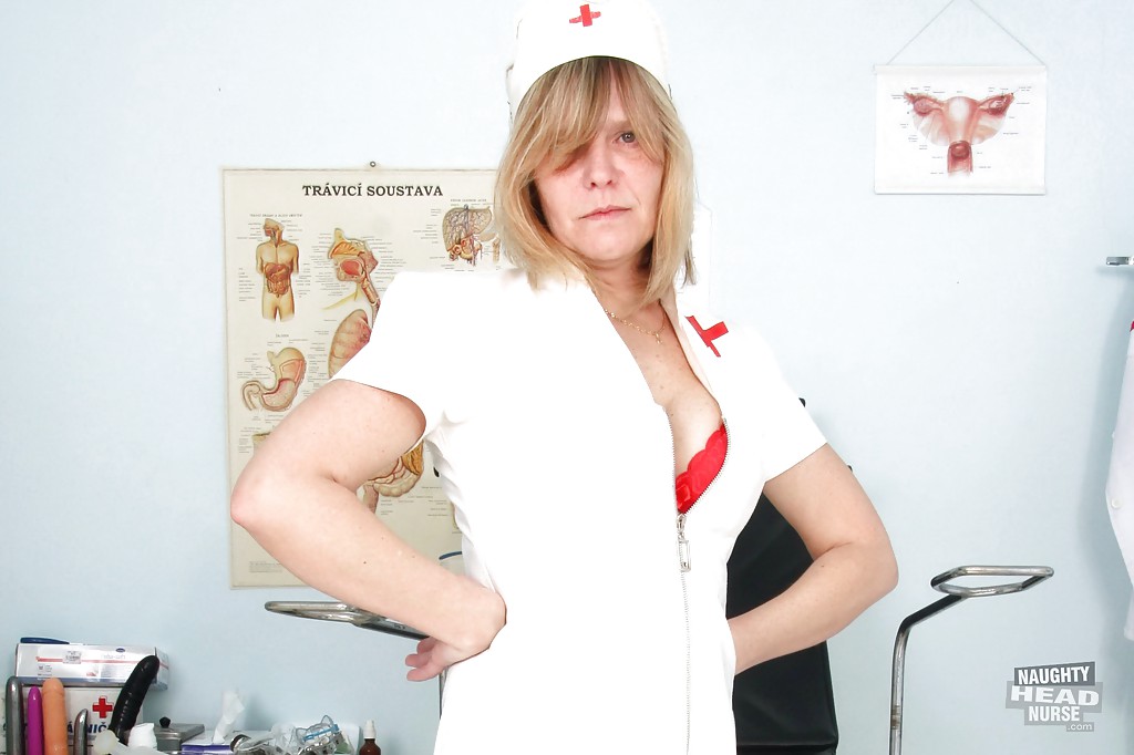 Raunchy mature lady in nurse uniform and stockings revealing her twat #50997095
