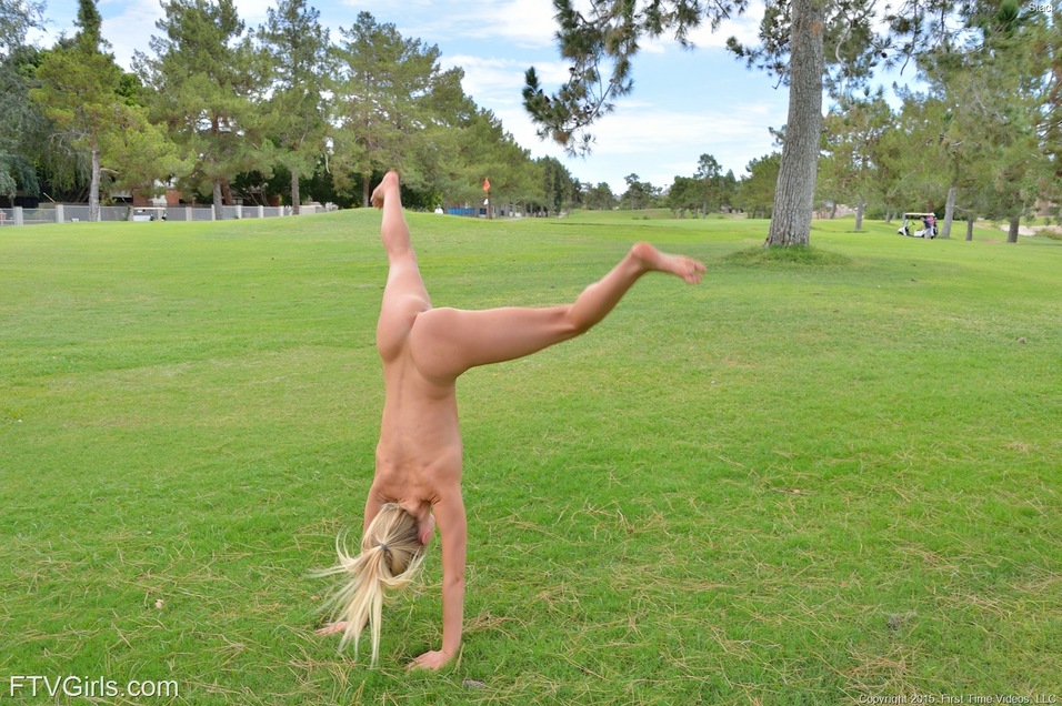 Sexy blonde girl shedding spandex pants and top to pose nude in public park #51416905