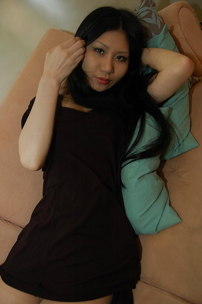 Slim asian babe Hitomi Nagase getting naked and spreading her legs
