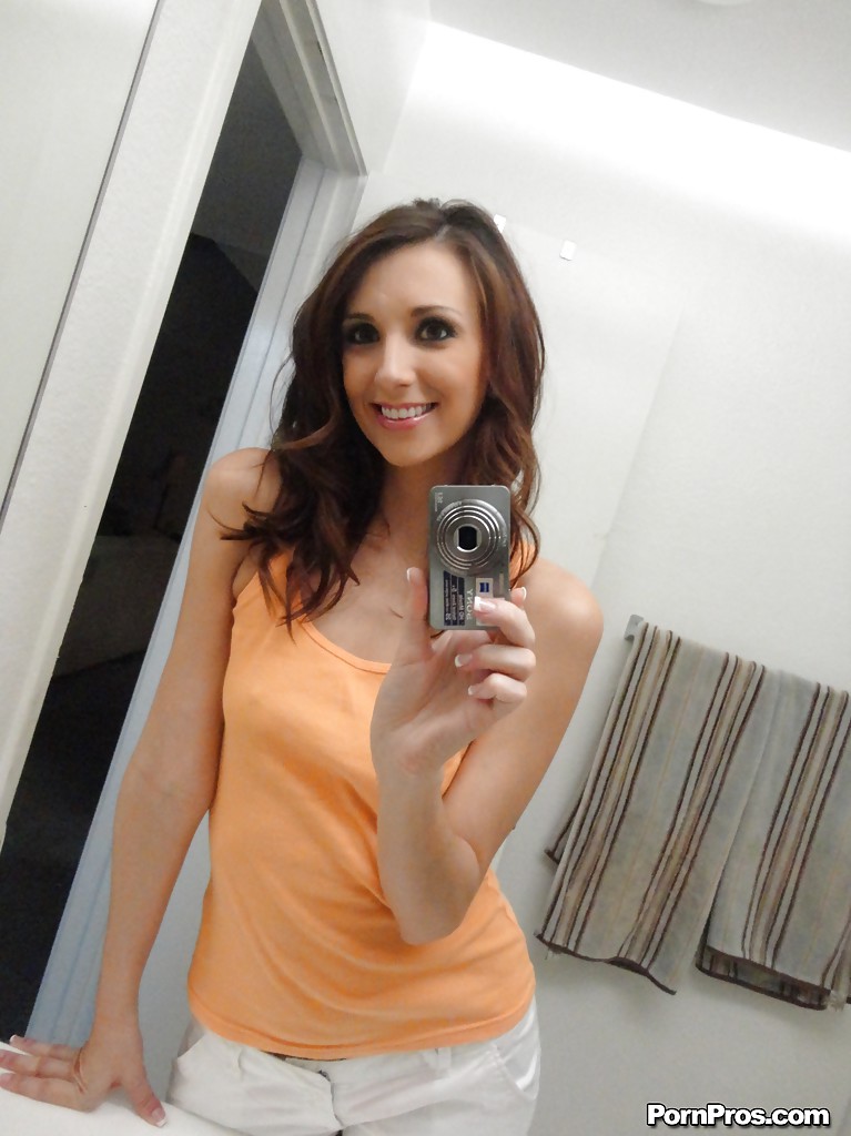 Adorable chick shows off her naked forms while taking photos of herself