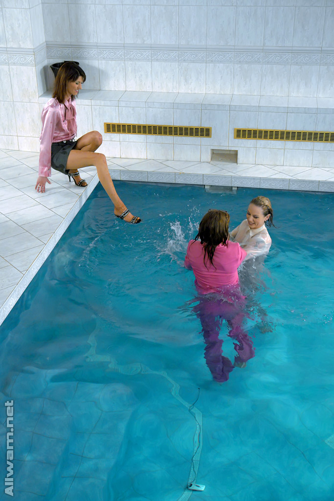 Fetichistas completamente vestidas divirtiéndose en la piscina
 #52626051