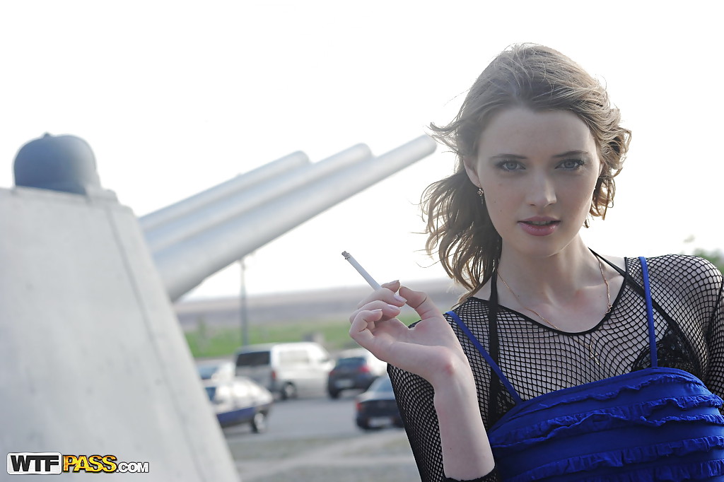 Una chica increíblemente encantadora en pantimedias fumando y haciendo upskirt al aire libre
 #51629113