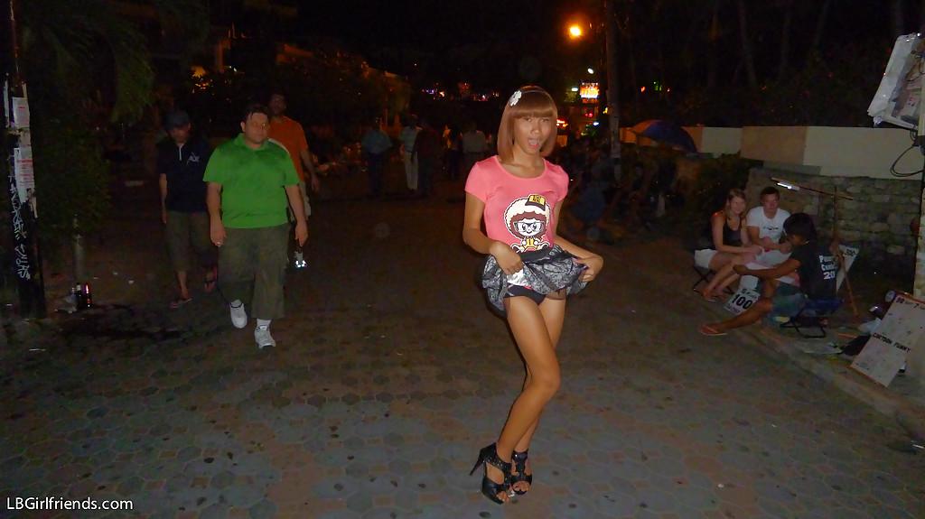 La delgada transexual asiática Jess posando al aire libre con falda y tacones altos
 #51249767