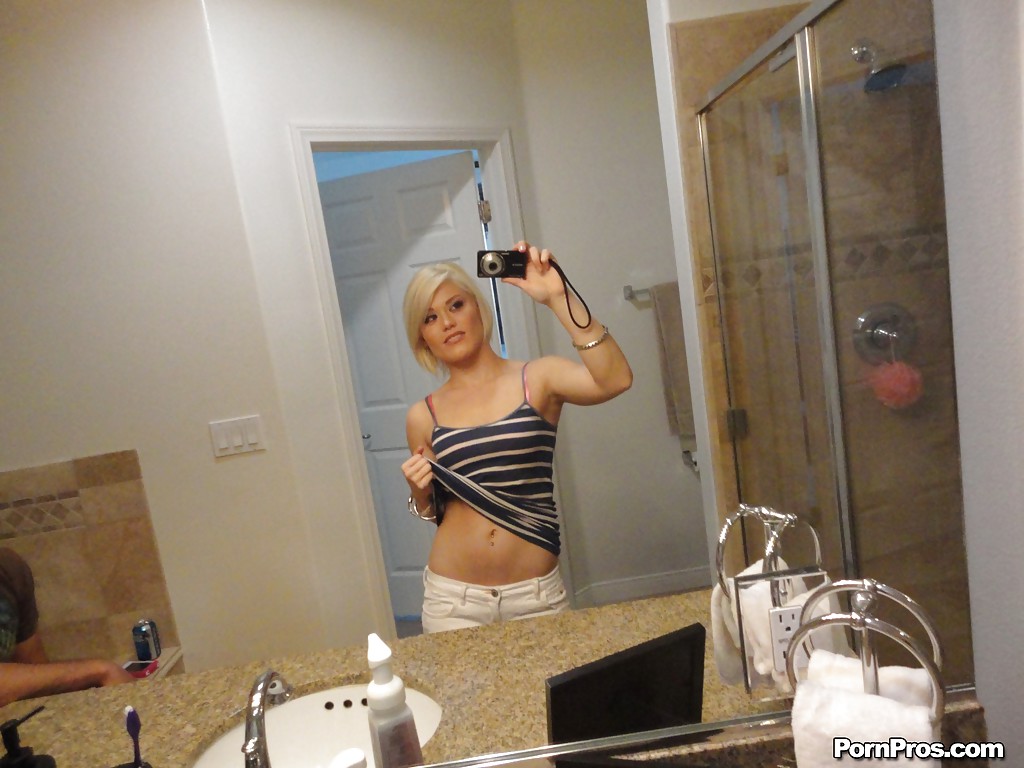 Young blonde hottie Ash Hollywood taking selfies in mirror while undressing