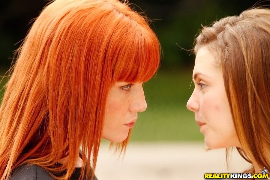 Adorable lesbian Kiera Winters making out with her buddy outside