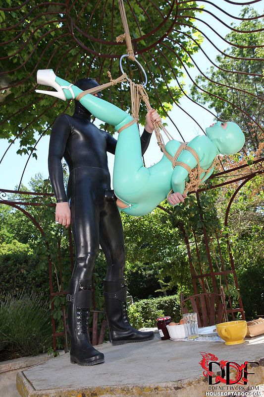 BDSM fetish model Latex Lucy suspended by ropes in latex outfit outdoors #50781272