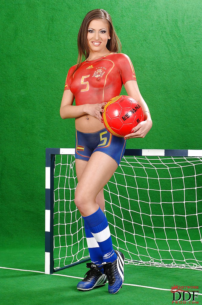 Sporty european babe Eve Mendes posing in body painted football uniform