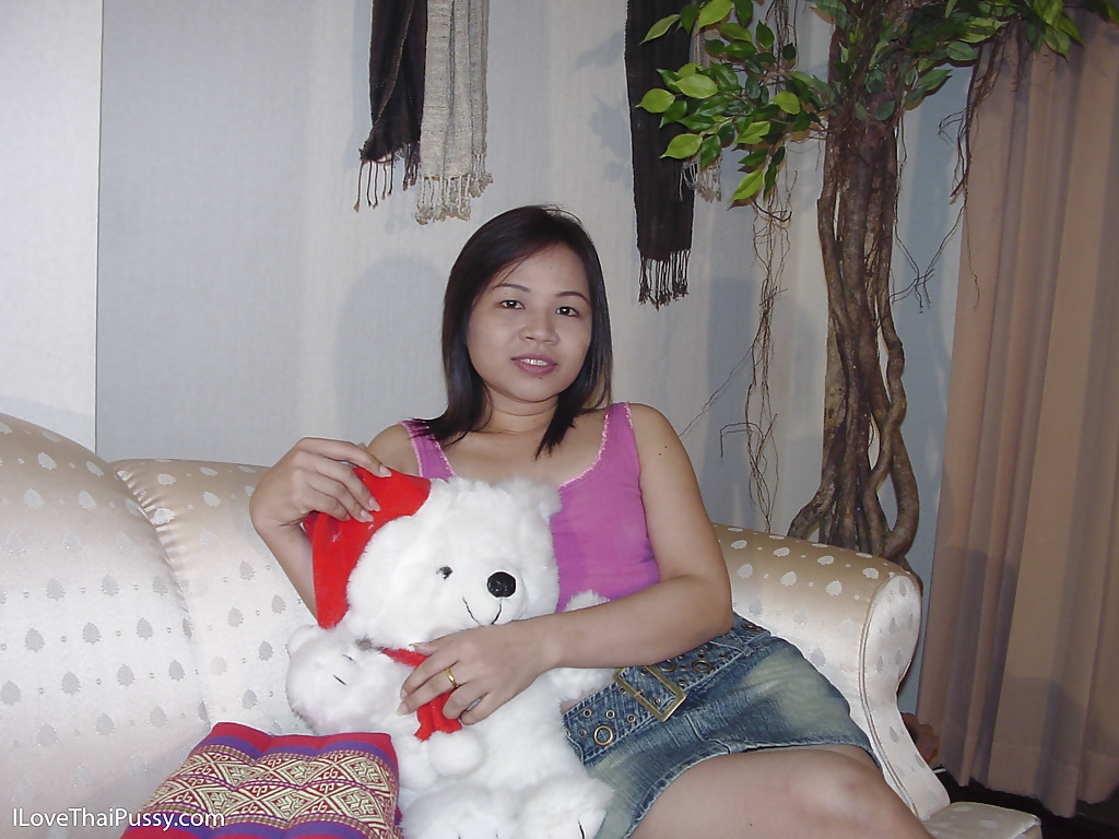 Chubby asian cutie taking off her clothes and posing naked on the sofa