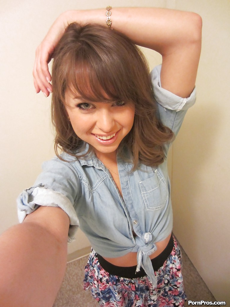 Clothed teen Riley Reid does some sexy self shots while in a toilet
