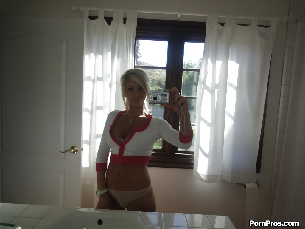 Blonde female Tasha Reign taking mirror self shots while removing her clothes