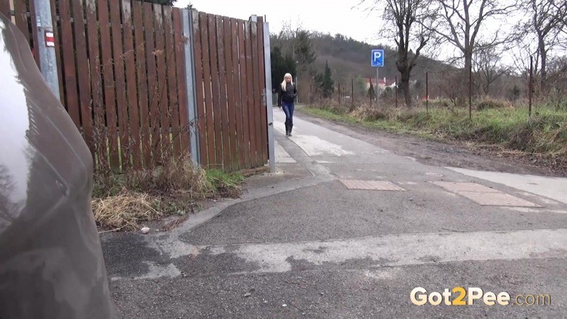 Une blonde pisse sur du béton comme un arrosoir
 #67496280