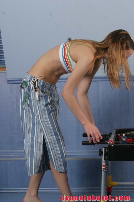 Two pretty teens playing table soccer #67381617