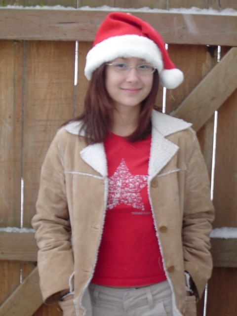 Asian teen sporting santa hat