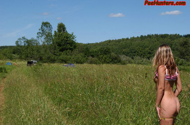 Beautiful teen peeing on the field #78615913