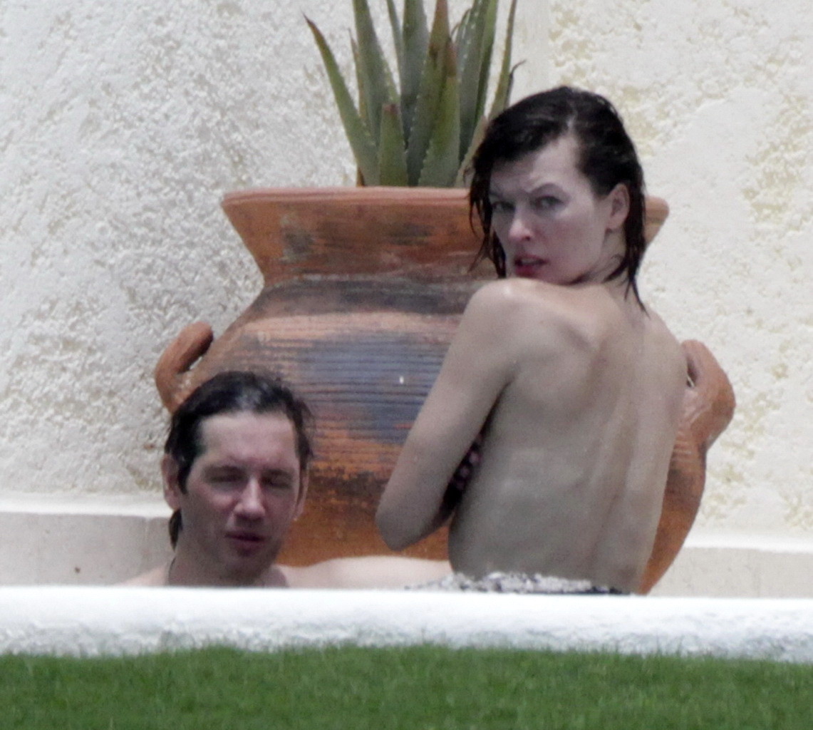 Milla Jovovich topless but hiding her boobs in Cabo San Lucas #75290555