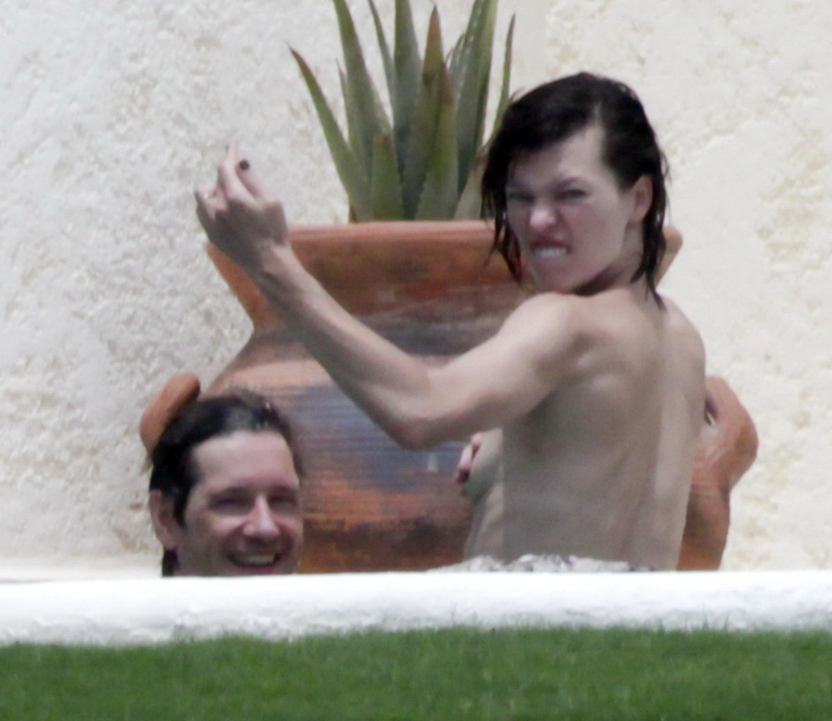 Milla Jovovich topless but hiding her boobs in Cabo San Lucas #75290559