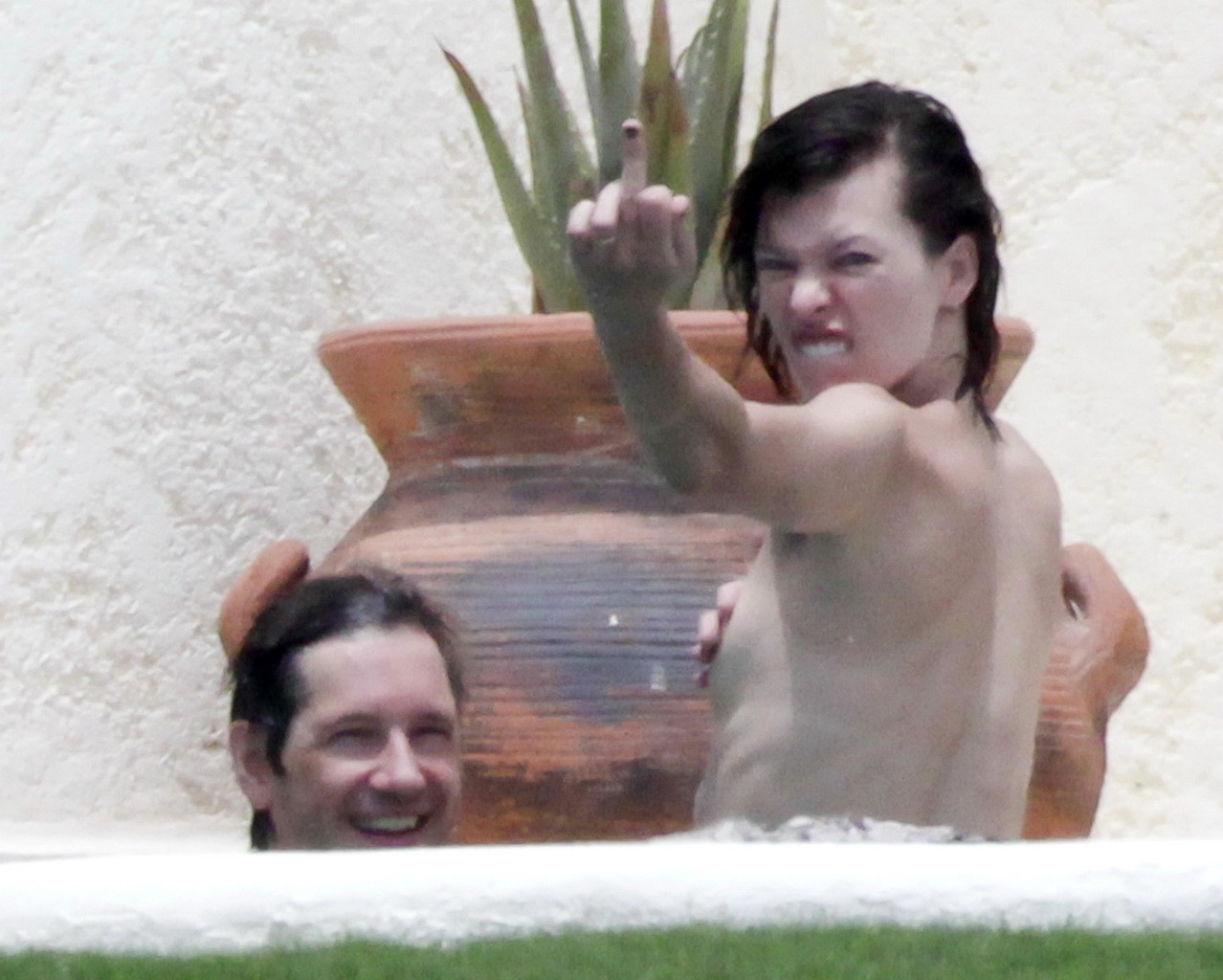 Milla Jovovich topless but hiding her boobs in Cabo San Lucas #75290568