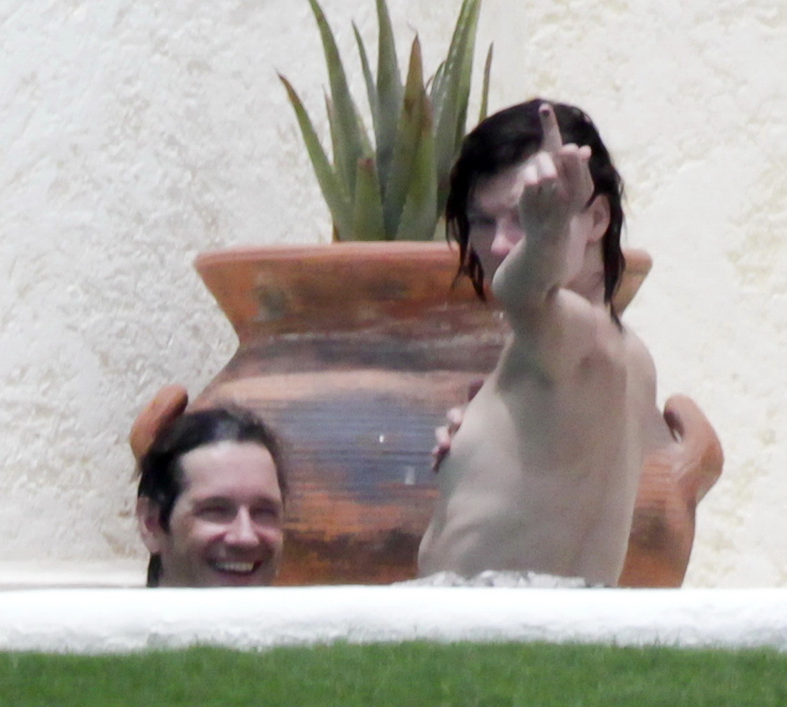 Milla Jovovich topless but hiding her boobs in Cabo San Lucas #75290574