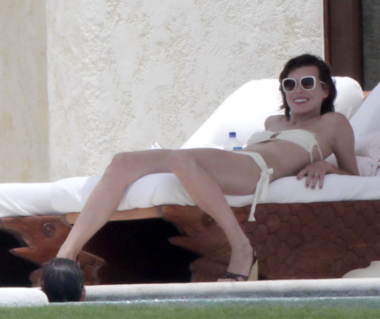 Milla Jovovich topless but hiding her boobs in Cabo San Lucas #75290632