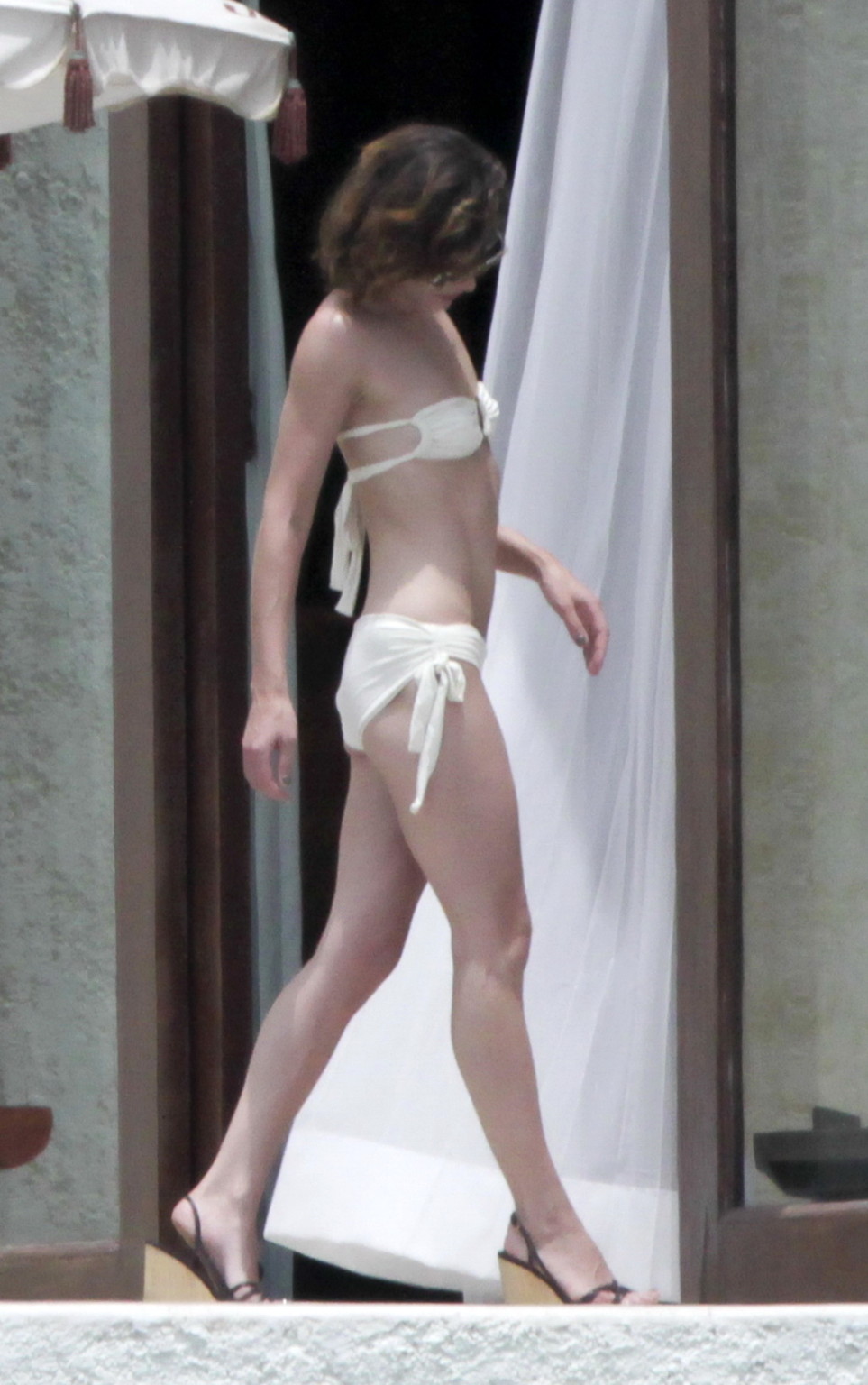 Milla Jovovich topless but hiding her boobs in Cabo San Lucas #75290669