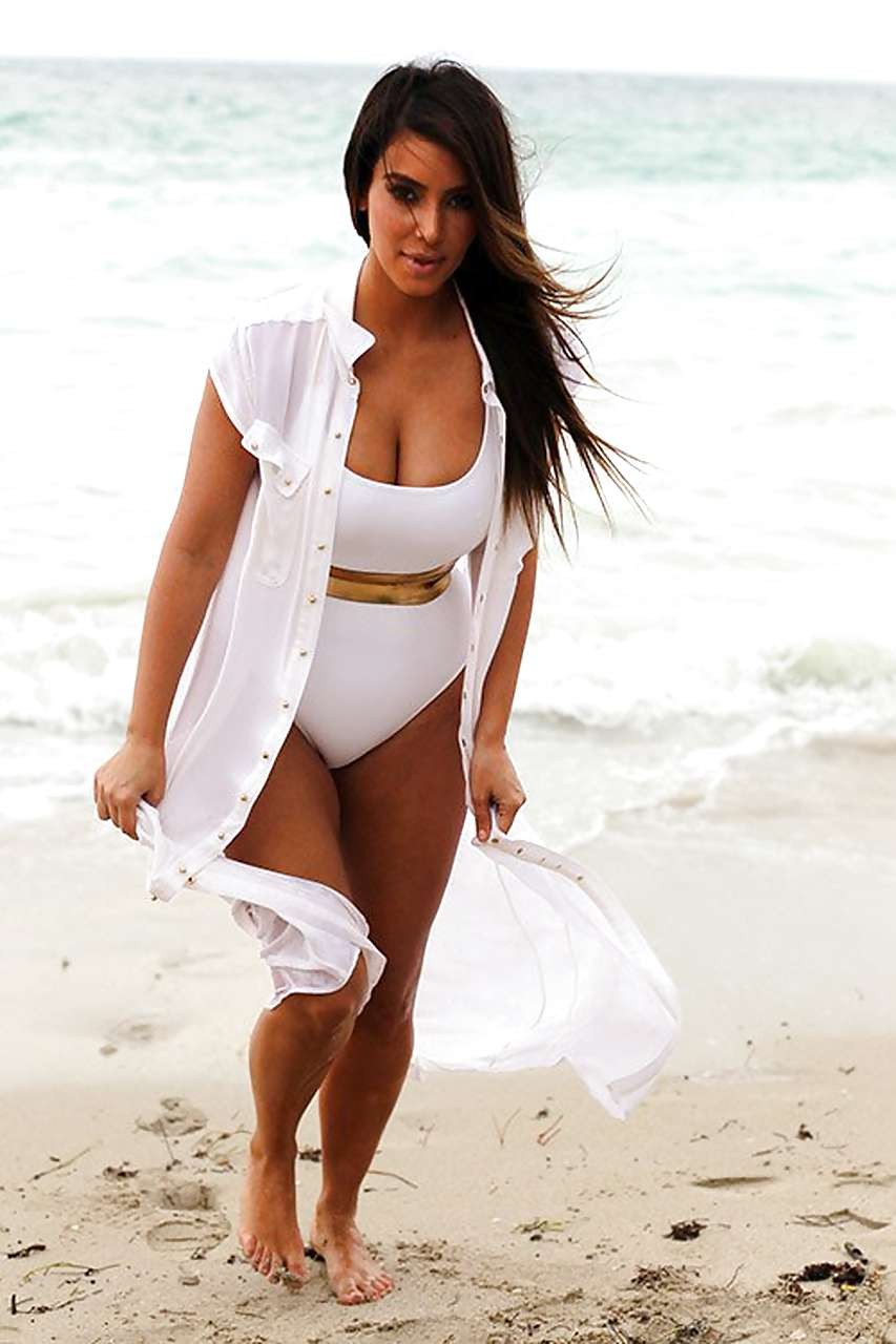 Kim Kardashian exposing huge boobs in swimsuit on beach