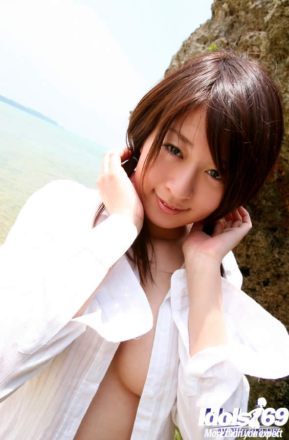 Cute japanese girl naked on a rocky beach #69939069