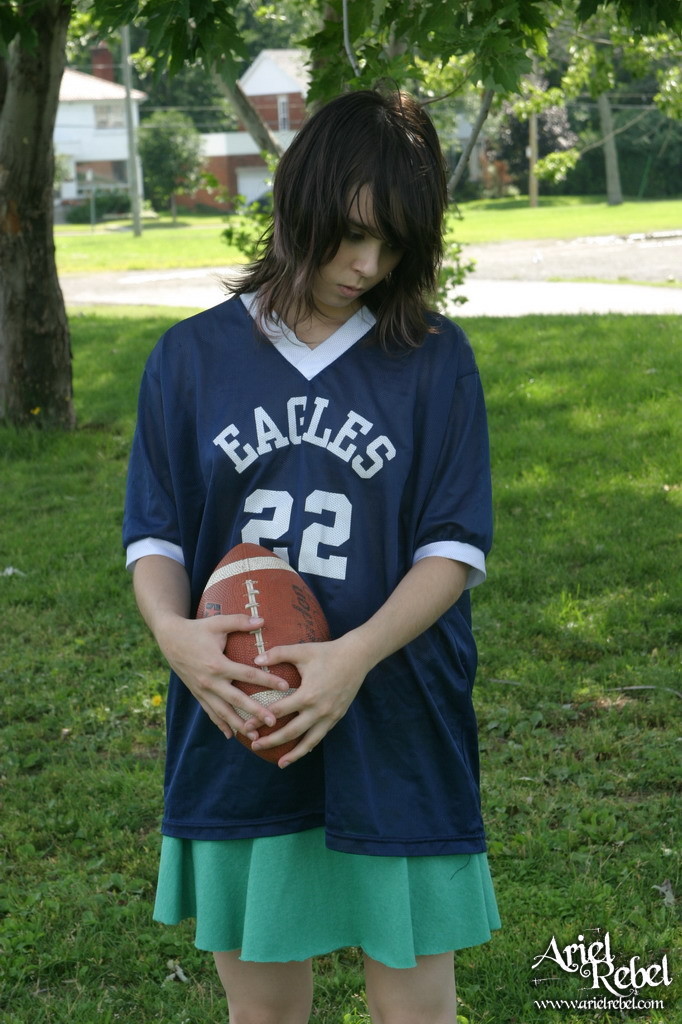Football loving teen girl outdoors