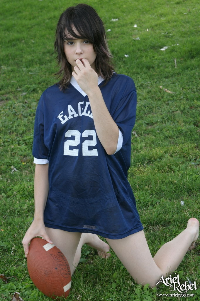 Football loving teen girl outdoors #67115793