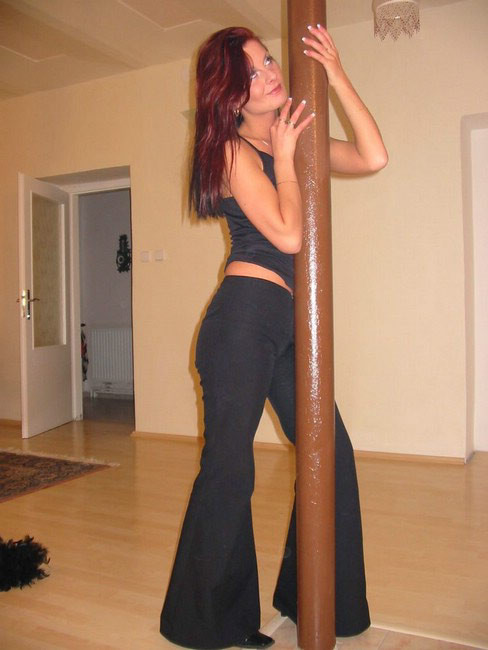 Brunette plays with pole #75079054