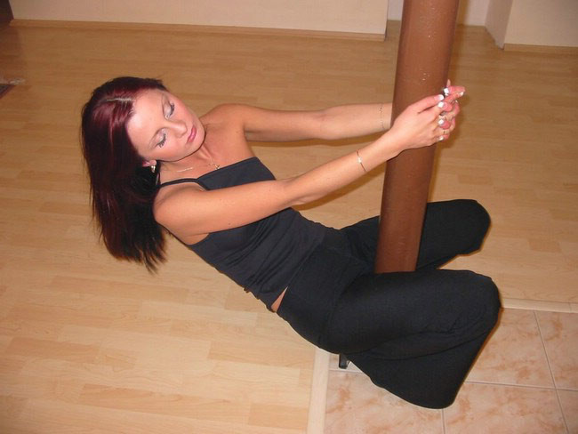 Brunette plays with pole #75079062