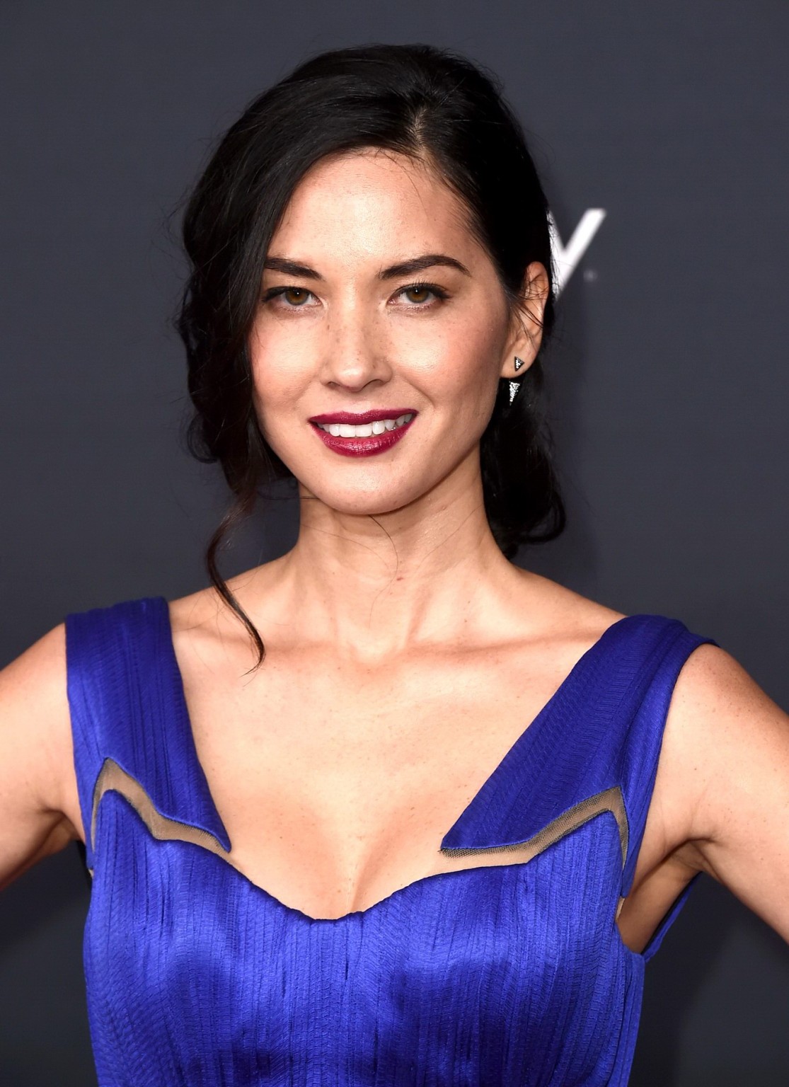 Olivia Munn wearing a low cut blue dress at the 4th annual NFL Honors in Phoenix