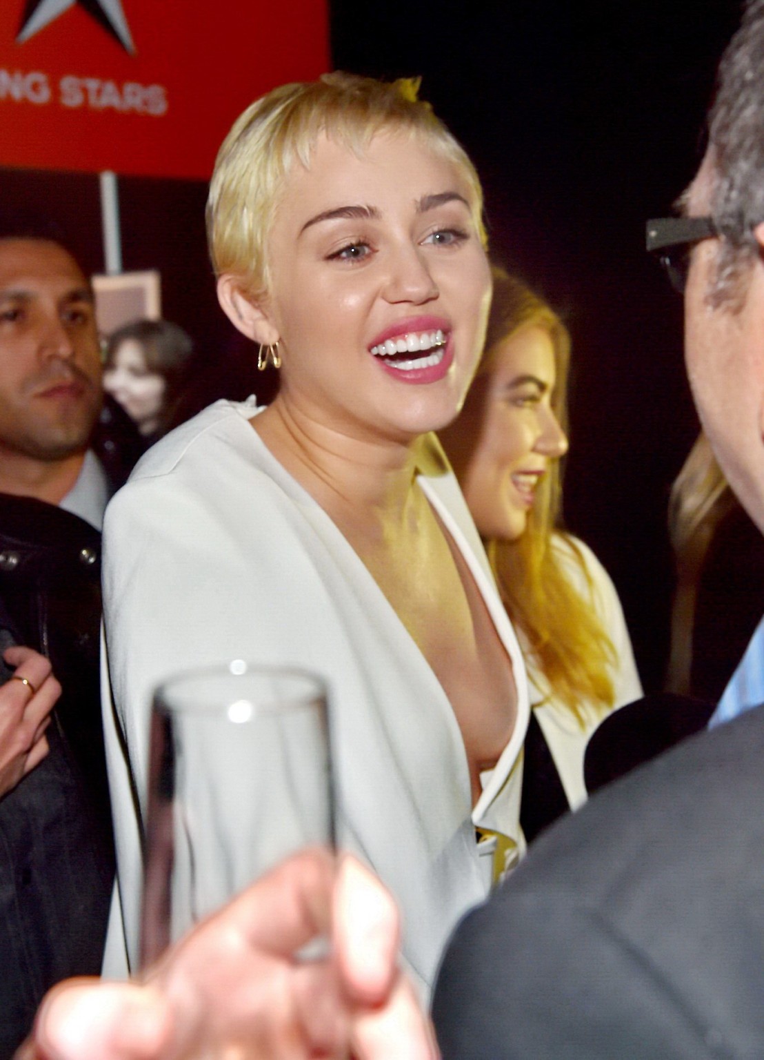 Miley Cyrus braless shows cleavage attending the W Magazine Shooting Stars Exhib #75175819