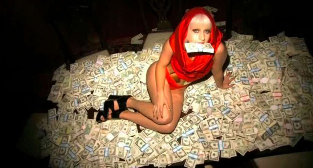 Lady Gaga posing very sexy and leggy on bed with money #75353767
