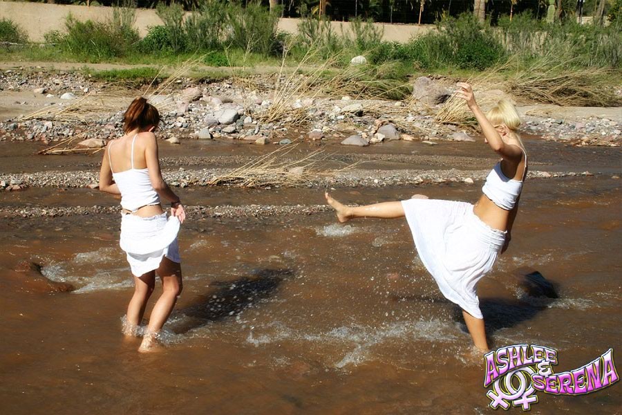 two teen girls kissing in a creek #78080706