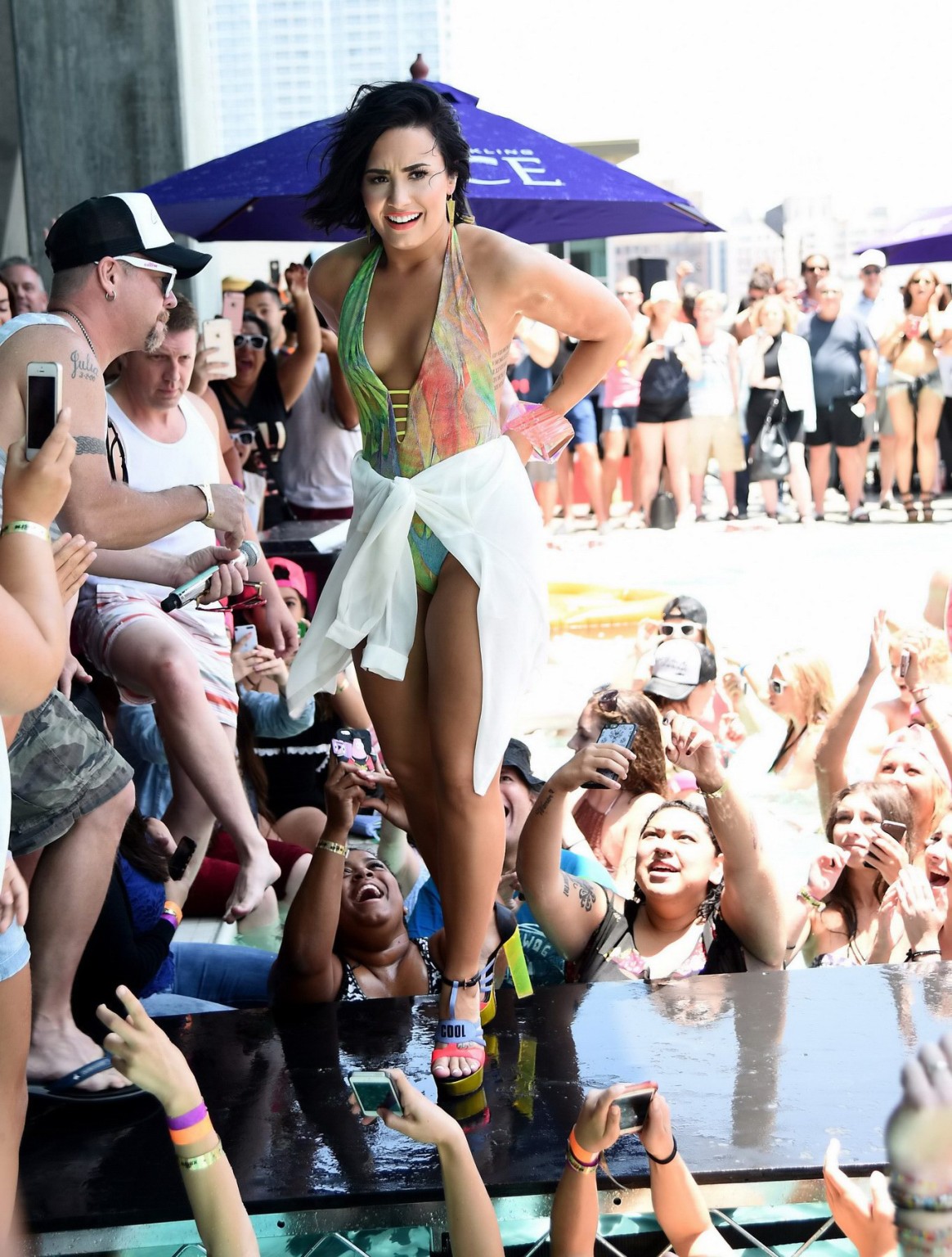 Demi Lovato getting moist in low cut swimsuit poolside