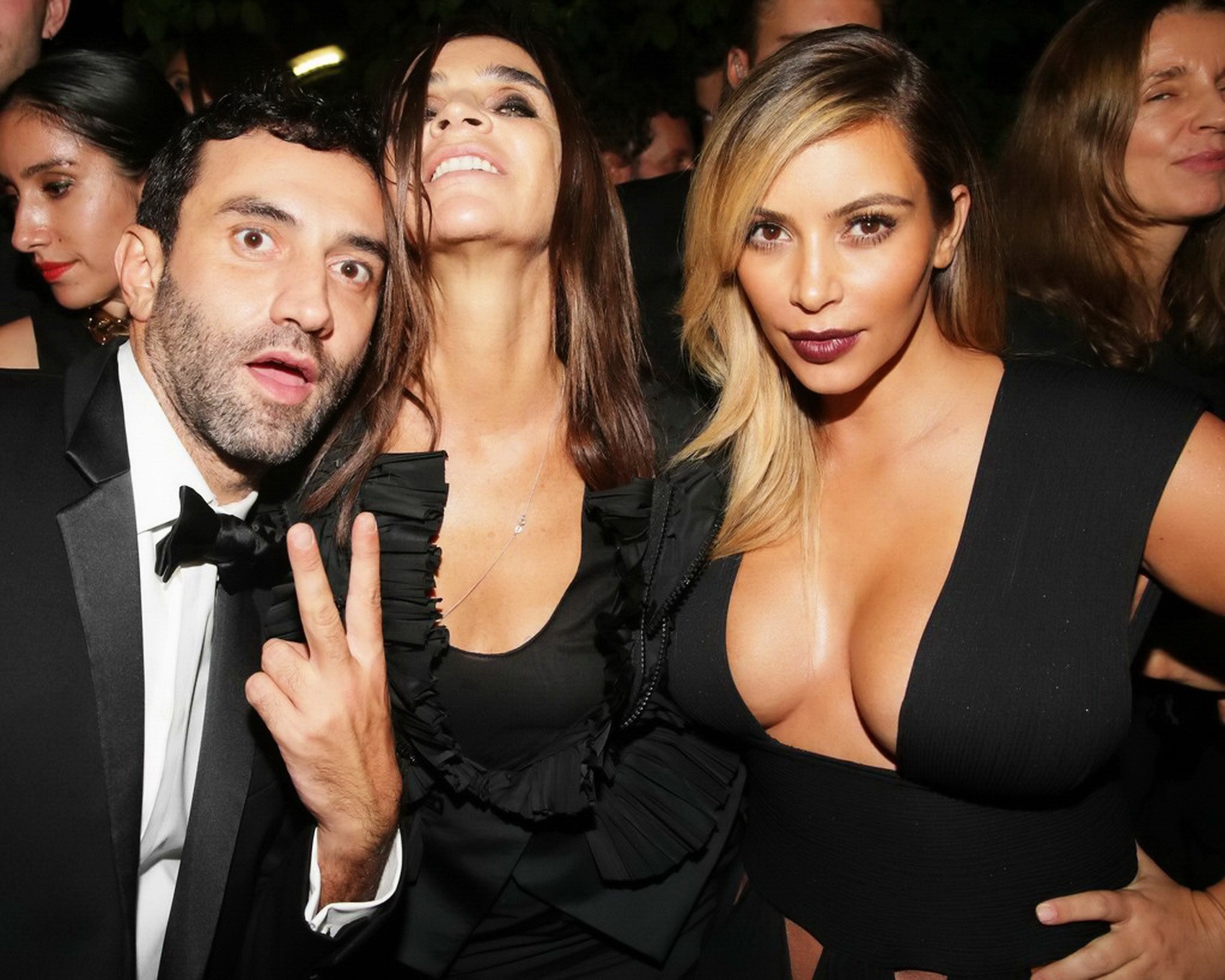 Kim Kardashian braless showing huge cleavage in a low cut black dress at the Mad #75216938