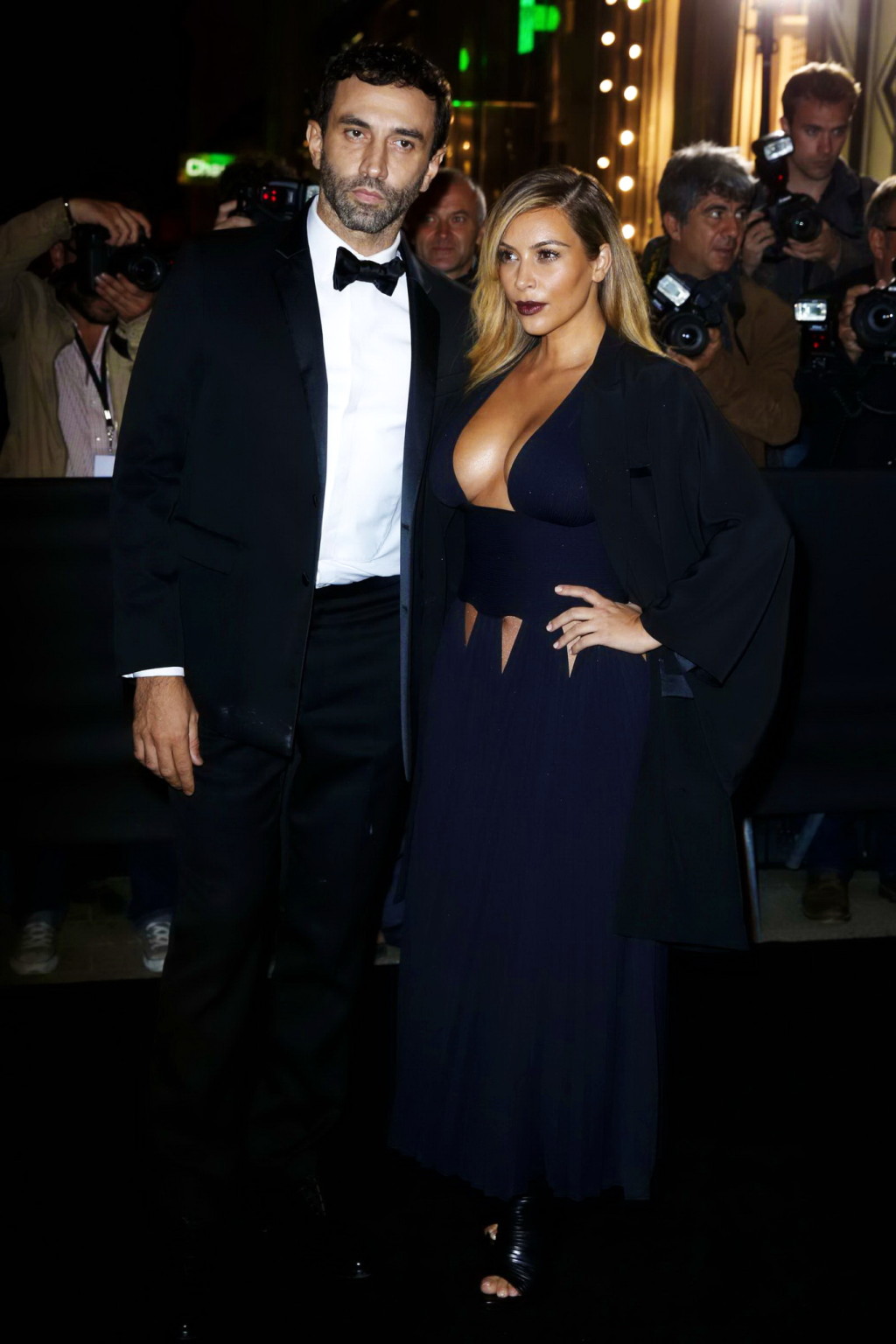 Kim Kardashian braless showing huge cleavage in a low cut black dress at the Mad #75216950