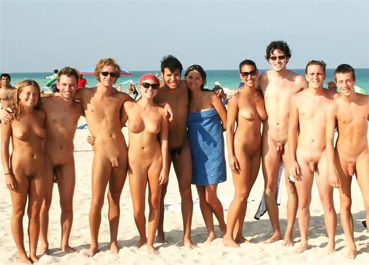 Naked teens play together at a public beach #70288580