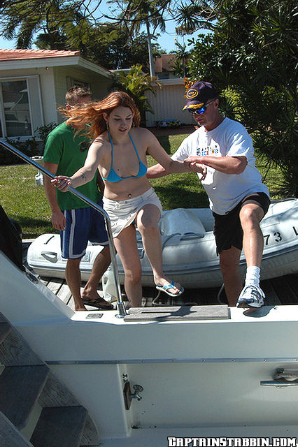 The captian fish hooks a redhead for a blow on the boat #68955650