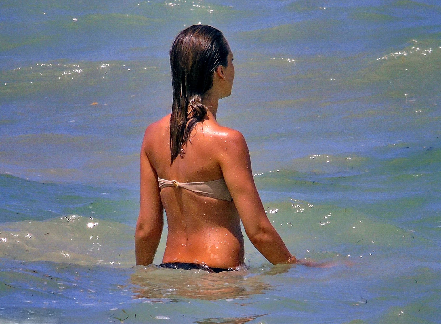 Jessica Alba wearing a strapless bikini on a beach in Mexico