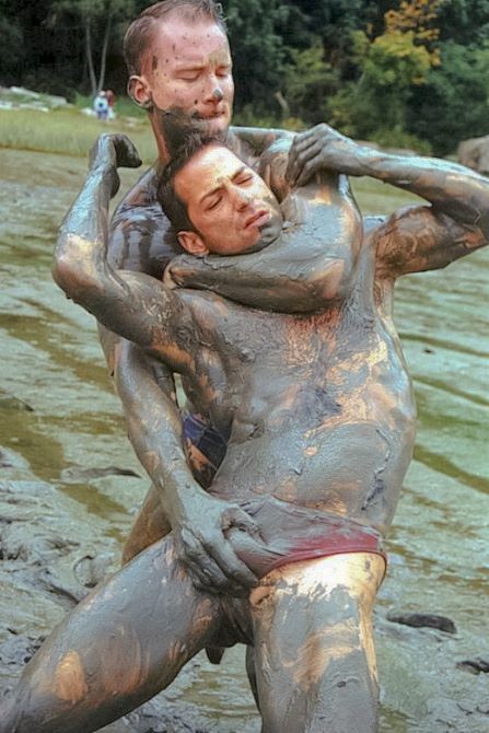 Muscle couple outdoor wrestling and thrusting the liquid mud #76947138