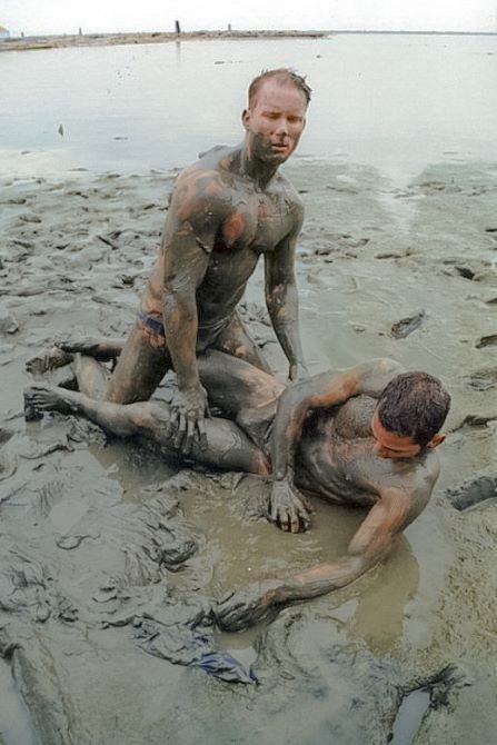Muscle couple outdoor wrestling and thrusting the liquid mud #76947145