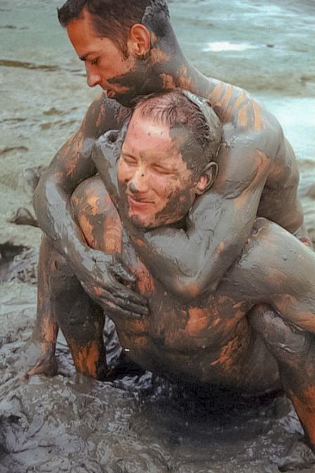 Muscle couple outdoor wrestling and thrusting the liquid mud #76947185