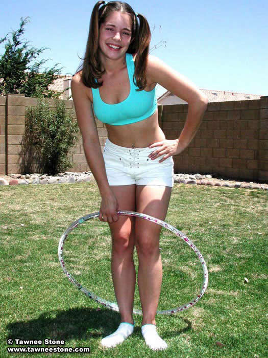 Brunette teen plays with a hula hoop #75052809