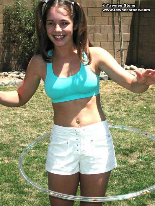 Brunette teen plays with a hula hoop #75052812