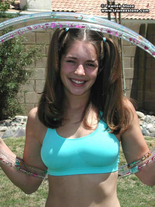 Brunette teen plays with a hula hoop #75052818